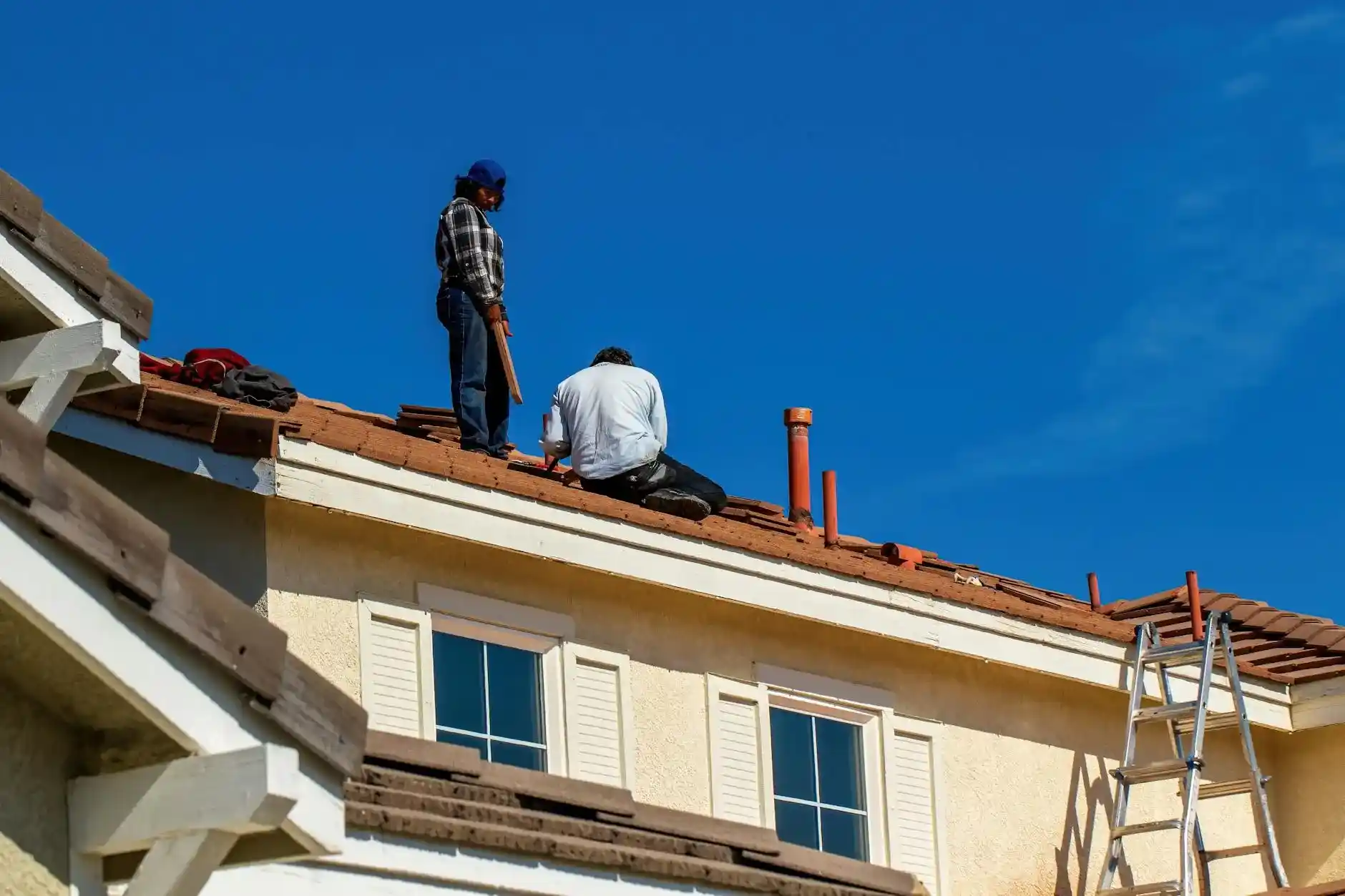 Red clay roof tiles on a Knoxville-area home against a clear blue sky